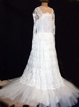 1959 Full length white lace and net over white taffeta slip.