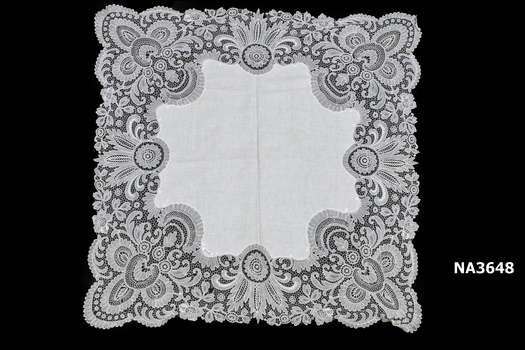 Cream linen supper cloth with wide border of machine made lace.