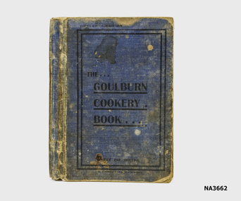 The book has a worn blue cloth cover with black print