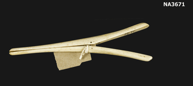 Cream glove stretchers. Two prongs joined at centre.