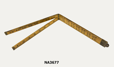Three foot rule, collapsible to nine inch. Metal ends and hinges. Hinge in centre 9inches from each end. Two small nails positioned at 14 and 22 inch marks and 10 and 26 inch marks to keep folded rule in place.