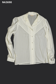 Cream polyester five pearl button fastening down front.