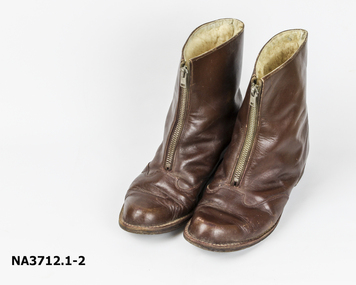 Brown leather boots with front zip. 