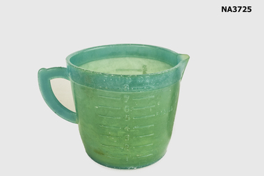 Green plastic measuring cup.