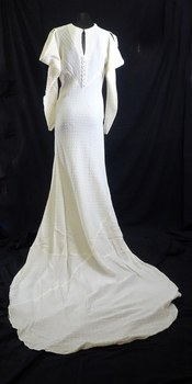 1936 cream seersucker dress featuring a cowl neck and long sleeve, slit at shoulder to create cowl effect. 