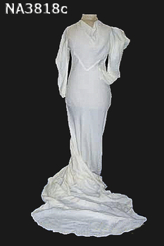 1936 cream seersucker dress featuring a cowl neck and long sleeve, slit at shoulder to create cowl effect.