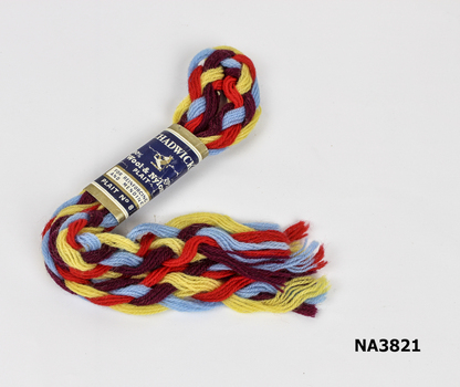 Plait contains red, yellow, maroon, blue threads