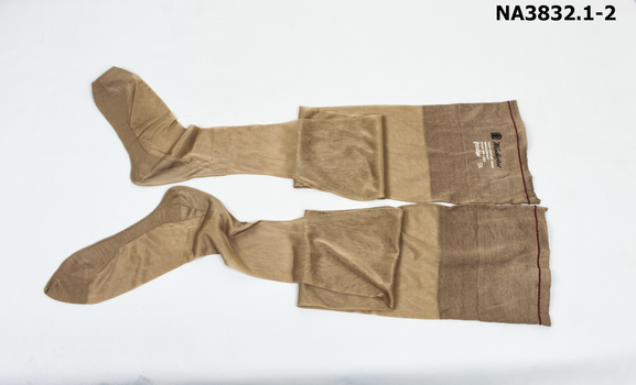 A pair of pinky-brown colour Service Stockings with lisle feet and top and back and foot seams.