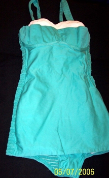 Pale green swimsuit, cream pin tuck insert forming the bra top. 