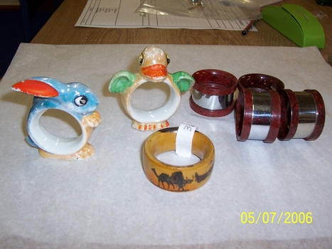 Round china ring with duck head & wing on top & feet to enable it to stand. 