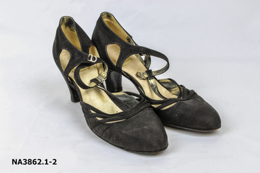Black T-bar high heeled shoes. 