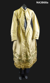 One piece old gold Paper Taffeta wedding gown, stand up collar, piped in green taffeta. 