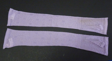 One pair mauve lace fingerless gloves to elbow, worn by a bridesmaid.