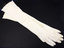  Pair of elbow length cream kid gloves, three pearl buttons at wrist