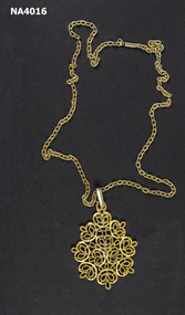 Gold coloured metal filigree pendant and chain.