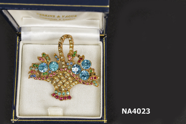 Gilt brooch in shape of basket with multi coloured stones