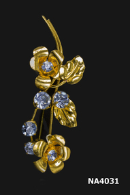 Gilt brooch two flowers each with a blue stone,four blue stones and two gilt leaves.