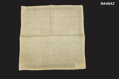 Cream woven place mat with small pattern around edges
