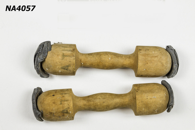 Pair of wooden dumbells with lead weights attached at each end.