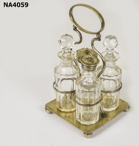 Metal and glass cruet set comprising of metal stand with four glass containers. 