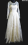 1958 Cream embroidered Nylon wedding dress. Fitted long sleeves to a point at waist, fastened with thirteen self covered buttons. 