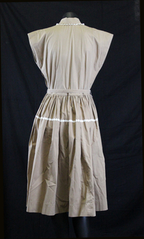 Light brown poplin day dress. Capped sleeves and Peter Pan collar.(back)