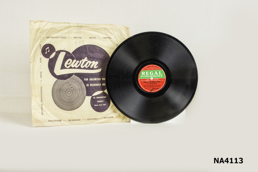 Flat, round Bakelite record with hole in centre -