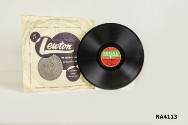 Flat, round Bakelite record with hole in centre -