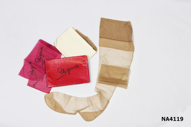 'Schiaparelli' stockings in red box with pink tissue paper around inside the box. 