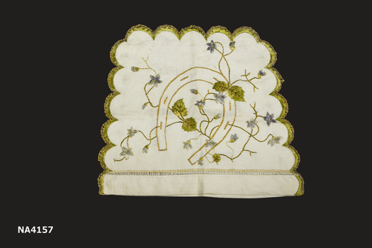 Cream linen tea cosy with scalloped edge. Both sides are embroidered in different colours and design.