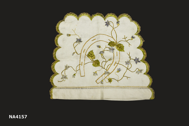 Cream linen tea cosy with scalloped edge. Both sides are embroidered in different colours and design.
