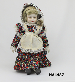 Porcelain head, hands, & half leg. Doll, shoes & socks painted, also painted face.