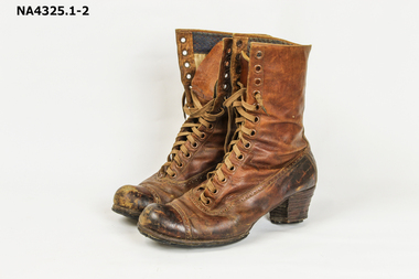 Brown boots - laced up - leather - heavily repaired on sole.