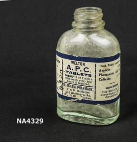 Clear small glass bottle with label