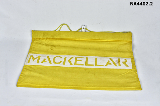 Yellow School house banners on wooden support with cord attached for hanging. 