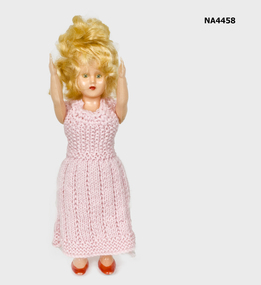 Twenty cm standing celluloid doll. Yellow hair.