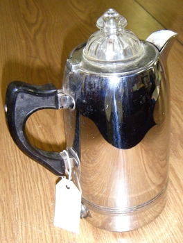 A metal (silver coloured) coffee percolator 