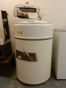 Simpson electric washing machine with wringer attached above bowl. 