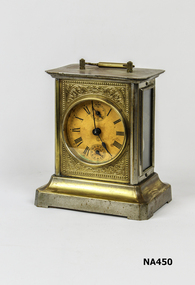 German Pendule de Portative, Eight Day  time clock. Movement by H.A.C. c.1900. Brass coloured with Roman numerals.  Handle on top.  Glass sides allow mechanism to be seen.