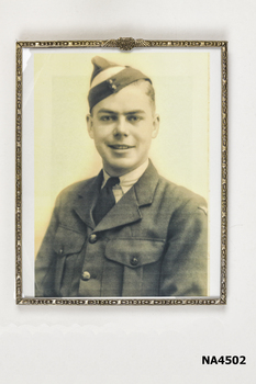 Brass frame with RAAF insignia on top of the frame which has a leaf pattern stamped on it.