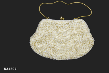 Small cream evening bag. Bead, pearl and sequin encrusted with gold coloured frame and handle.