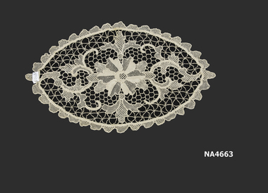 Doyly. Oval, 38cm x 27cm,  Needle Lace.