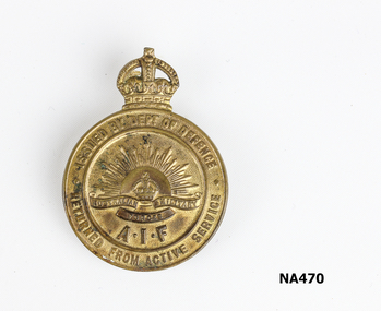 Brass medal with Crown on top, Rising Sun emblem and AIF inscribed. Around the edge - Issued by Dept. of Defence Returned from Active Service