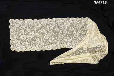 Cream machine made lace shawl. 