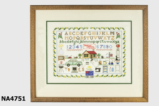 Embroidered sampler in a wooden frame. 