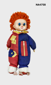 Toy clown doll with plastic head and hands, vinyl feet and soft body.