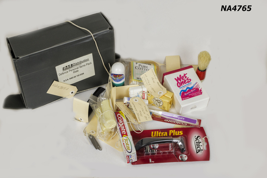 Dark grey cardboard box containing a varieties of toiletries.