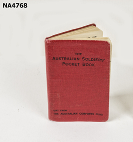 A small red book 'The Australian Soldiers Pocket Book' printed on cover. 