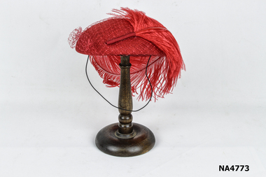 .Small red straw hat with large  red feather and red veiling