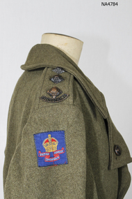 One khaki woolen army great coat, wide lapels wide cuffs, double breasted, four sets of medal buttons.